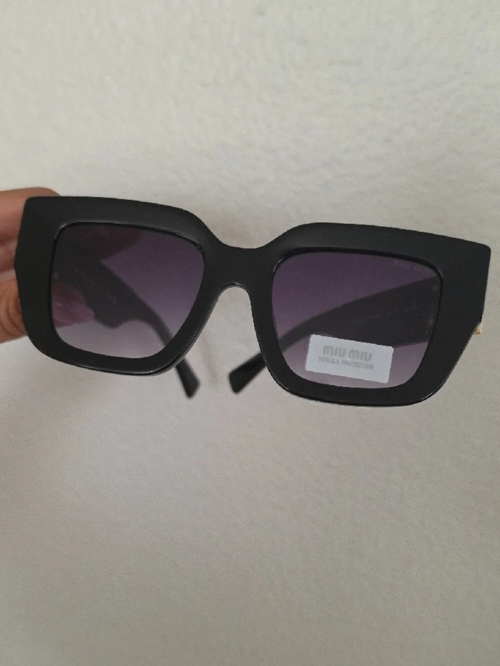Miu Miu Glossy Black Frame Sunglasses with Purple Lenses
